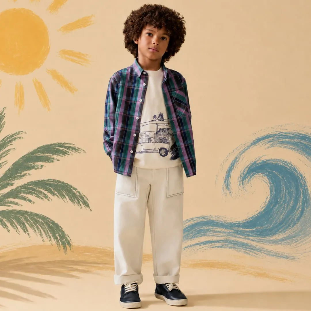 ATLR Paris visual: a boy in a plaid shirt and cream trousers in front of a painted beach backdrop