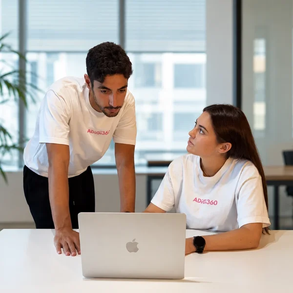 Alexis and Chloé, ADIGI360 co-founders, working together on a laptop at the office